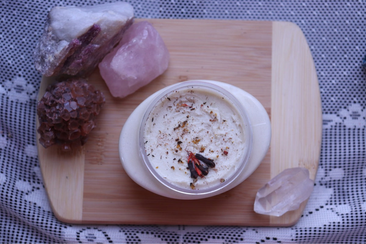 Shea Butter surrounded by crystals on a Wooden Board on top of lace
